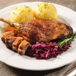 Crusty goose leg with braised red cabbage and dumplings