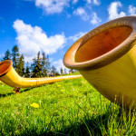 alphorns at a mountain peak - bavaria