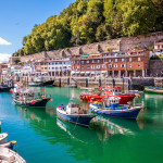 Fishing port of Donostia-San Sebastián with boats and blue sky