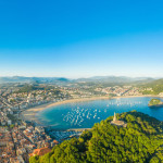 Fantastic aerial perspective of Donostia - San Sebastian city. View of the statue of "Sagrado Corazón de Jesús" - above Motako Gaztelua Castle on top of Santa Clara Island. In background the city.